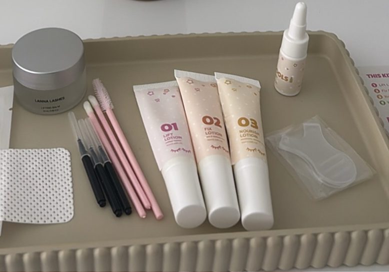 The Korean lash lift kit laid out on a tray: silicone pads, brushes and three numbered lotions